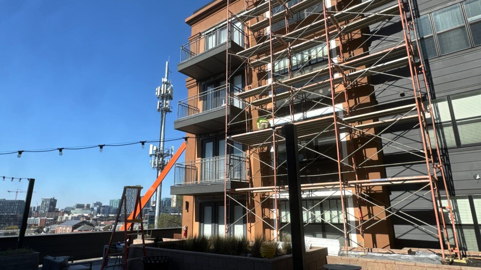 Multifamily building exterior under renovation with scaffolding